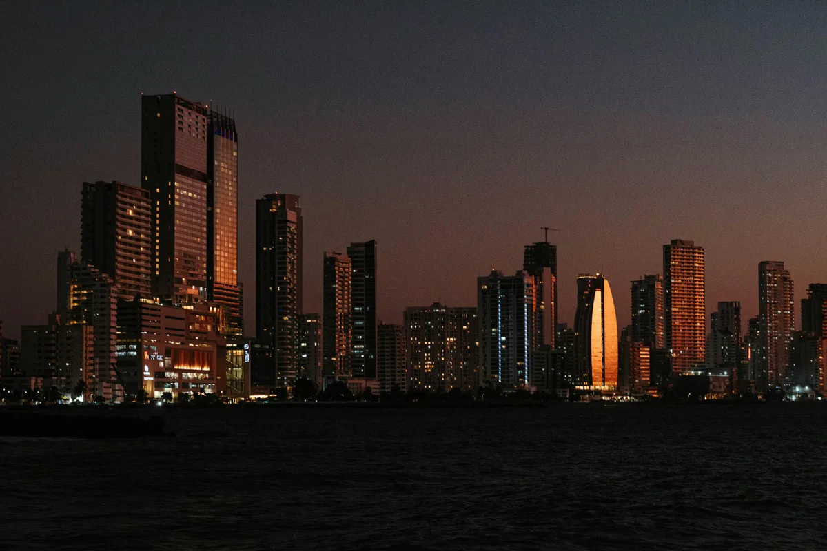 The illuminated skyline of Cartagena de Indias at dusk, the backdrop for starting a small business in the city