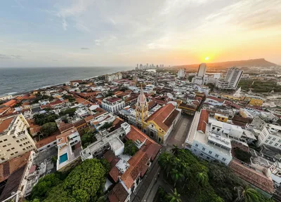 A breathtaking aerial shot of Cartagena's historic district at sunset with vibrant architecture and ocean view.