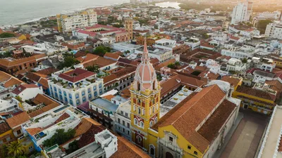 A drone shot capturing the vibrant architecture of Cartagena's historic center at sunset.
