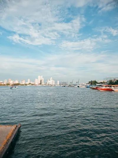 A beautiful harbor view of Cartagena de Indias, showcasing urban skyline and moored boats.