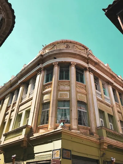 Low angle view of a historic building facade in Cartagena, Colombia under a blue sky.