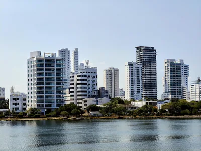 Panoramic view of modern skyscrapers in Cartagena, reflecting on the water during a sunny day.
