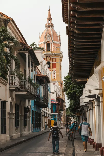 Scenic street scene in Cartagena featuring the iconic cathedral tower.